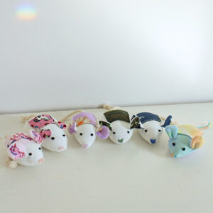 Pictured: 6 handmade tooh fairy helper mice in a semi circle, all the ears and pouches on their back are different colours. On a hiwt background